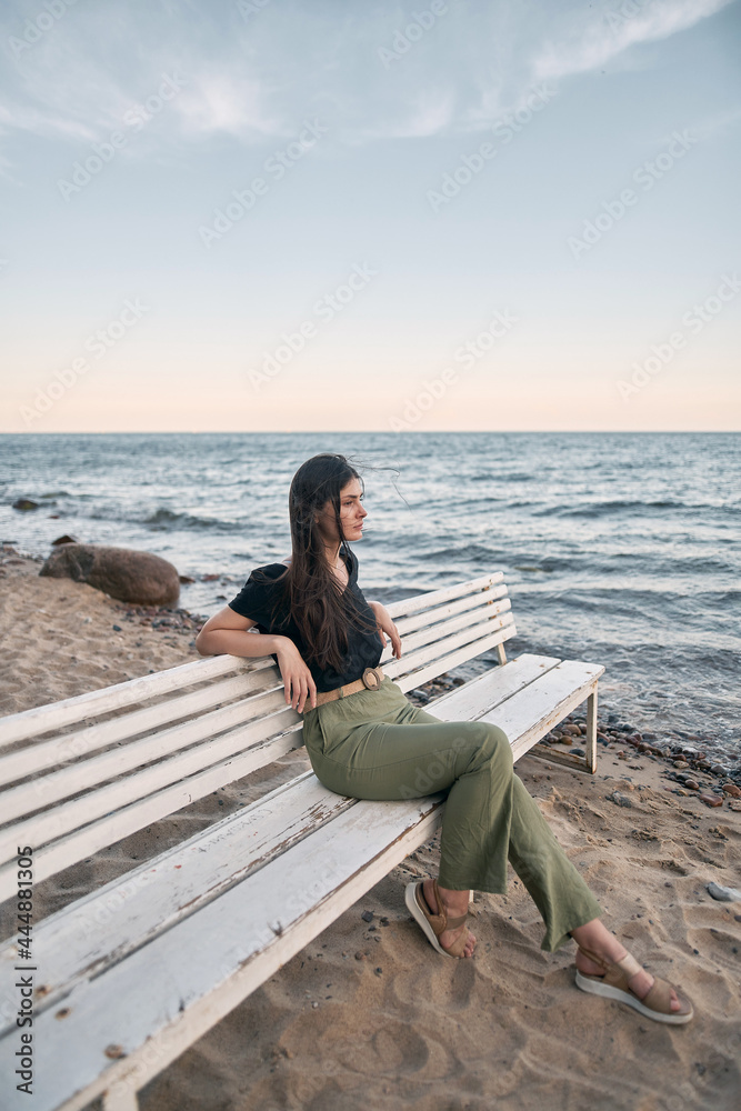 Lonely woman on the beach. COncept photo of depressed emotion and loneliness