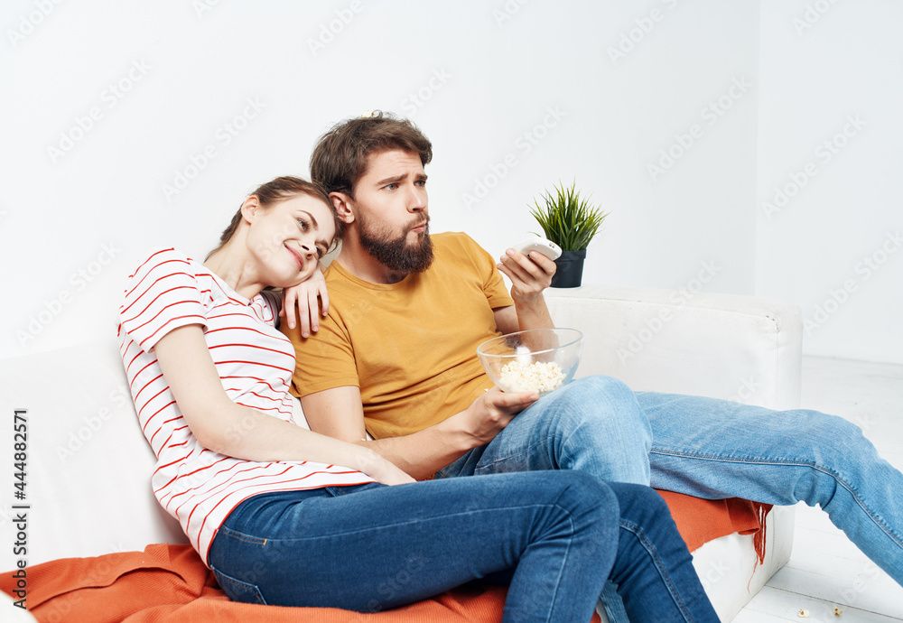 young couple sitting next to popcorn watching tv rest young couple sitting next to popcorn watching tv rest