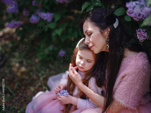 woman with daughter having fun outdoors in spring