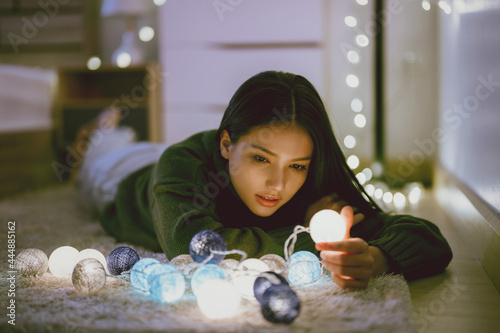 Obraz na plátně Asian woman stay home alone she is playing with lights