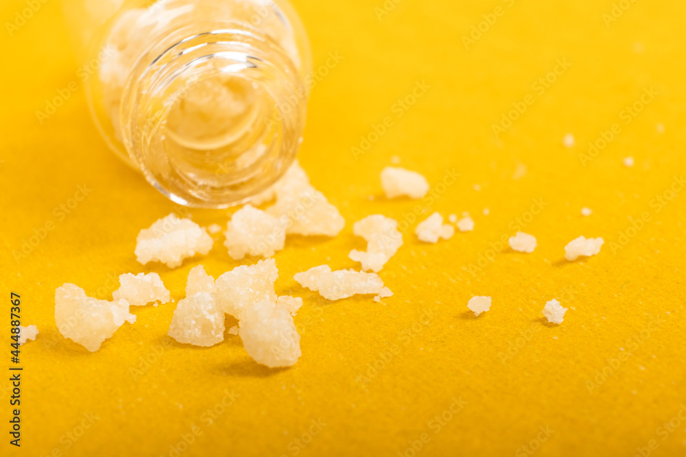 narcotic salt crystals amphetamine on yellow background - obrazy, fototapety, plakaty 