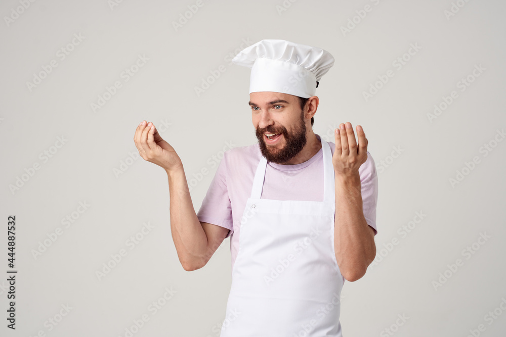 cheerful male chef in uniform gestures with his hands gourmet restaurant