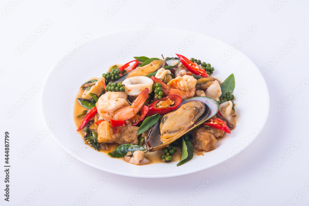 Seafood stir Fried Basil in the white dish.