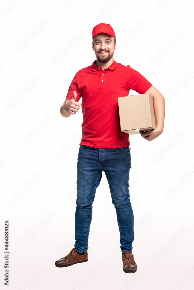 Delivery man with parcel showing thumb up on white background Delivery man with parcel showing thumb up on white background