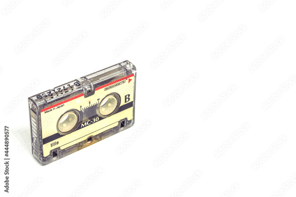 Obraz premium 1980's magnetic audio micro cassette isolated on white background