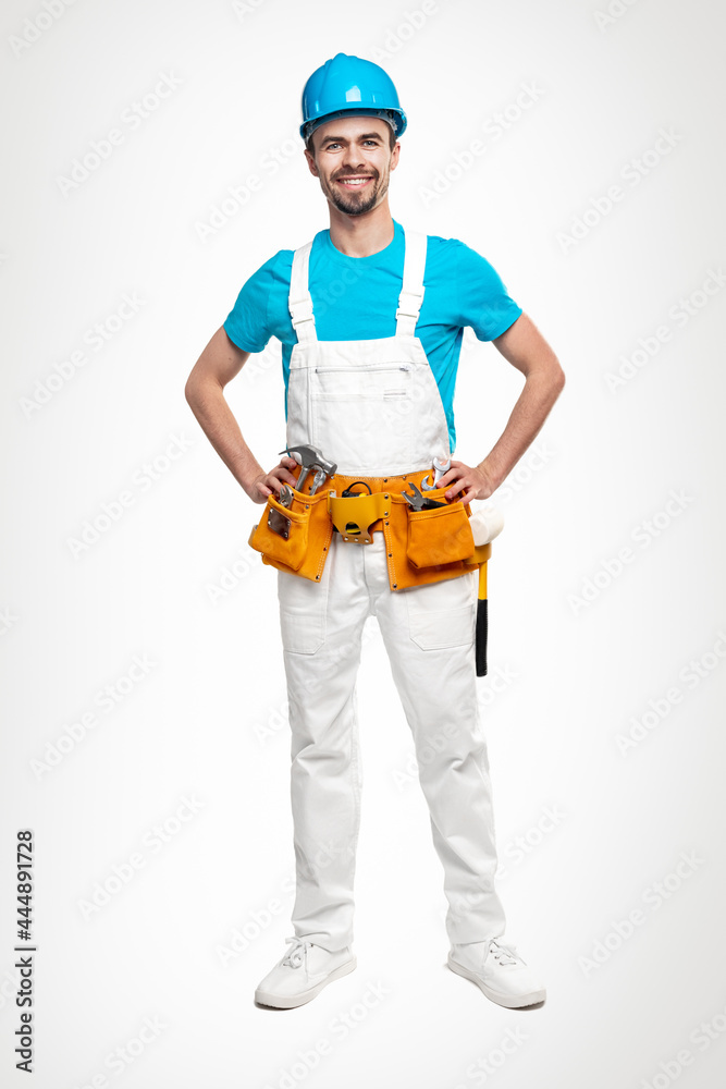 Confident repairman in uniform with tool kit