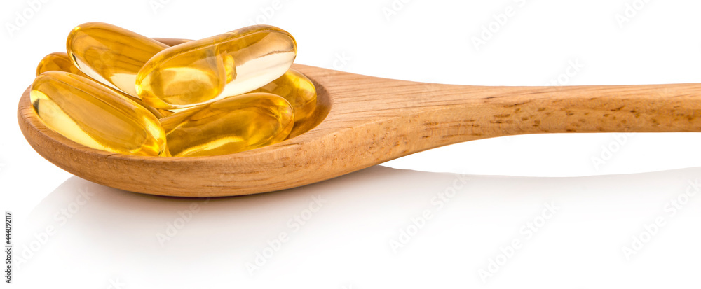 Fish oil capsules in a spoon
