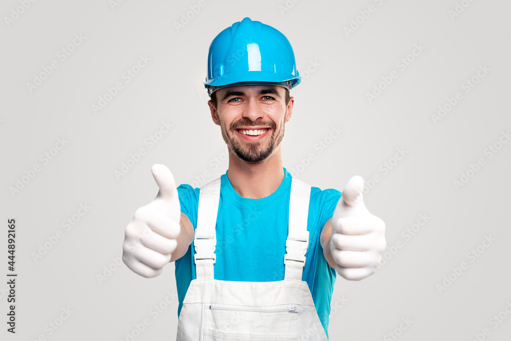 Confident builder in workwear showing thumbs up