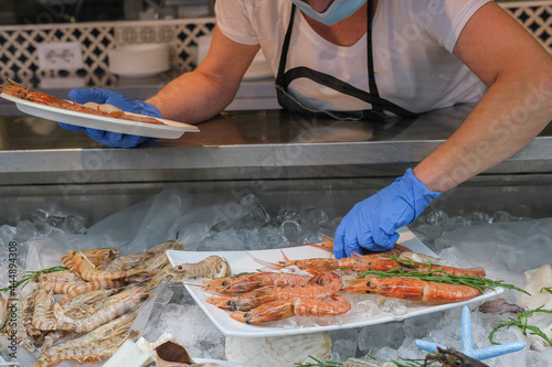 Fresh seafood and fish on the market. Tuna, perch, shrimp, squid, langoustines on ice photo