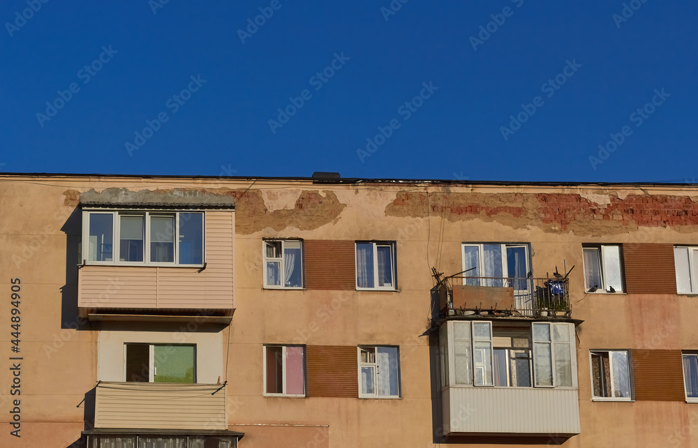 Fototapeta premium View of an old apartment building. Facade background of an old high-rise building.