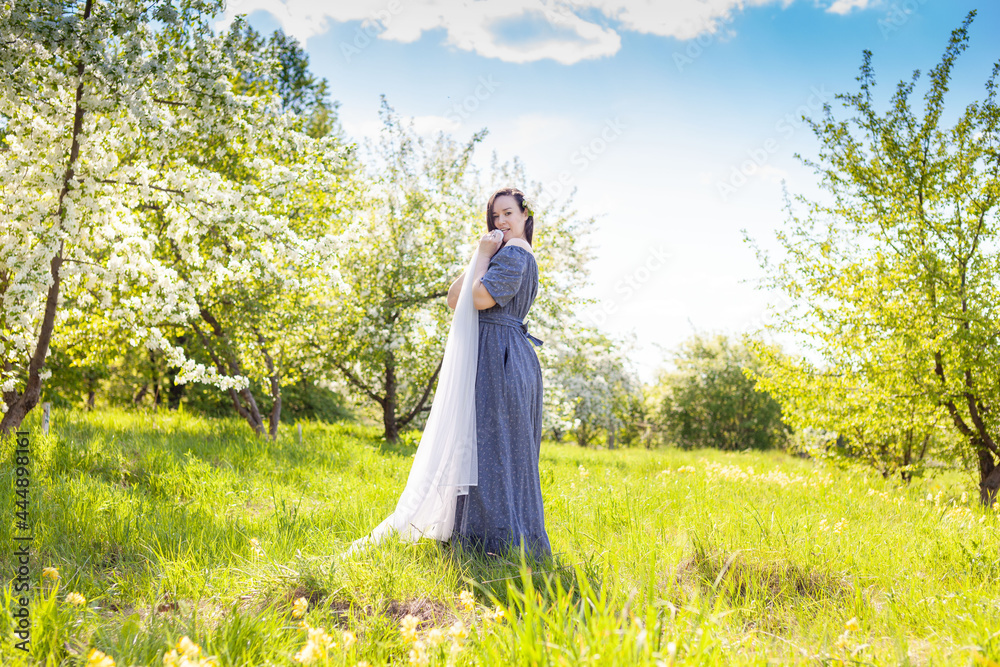 Happy brunette woman in blooming garden Happy brunette woman in blooming garden
