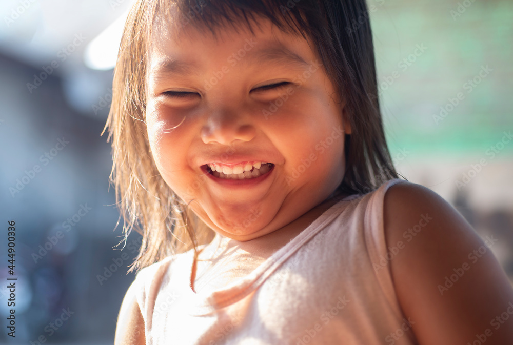 Portrait of a child's face smiling happily.