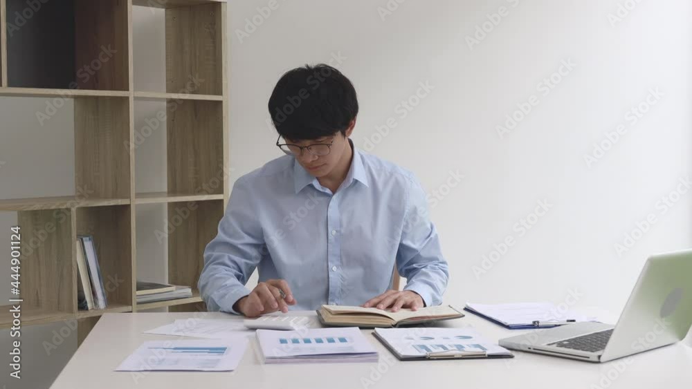 Businessman presses a calculator to calculate earnings in his private office, Information in finance and accounting, Company performance and revenue. Businessman presses a calculator to calculate earnings in his private office, Information in finance and accounting, Company performance and revenue.
