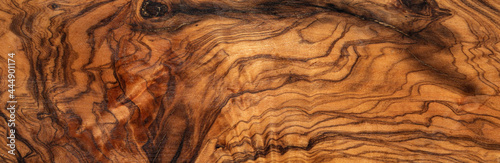 texture of dark brown olive wood plank. background of wooden surface