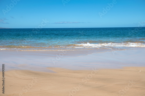 Sea background  nature of tropical summer beach with rays of sun light. Sand beach  sea water with copy space  summer vacation concept.