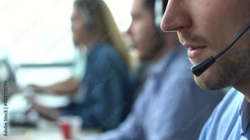 Male representative call center agent in wireless headset helping client, operator working in customer support service