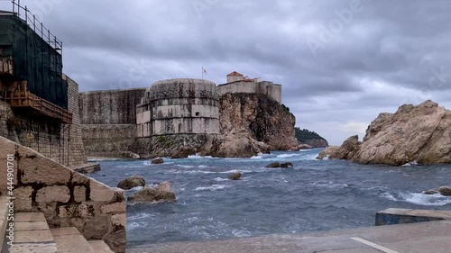 Bay in Dubrovnik with old Town City Walls and waves Crashing