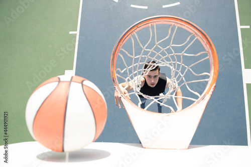 Basketball player. Sports and basketball. Man jumps and throws a ball into the basket.