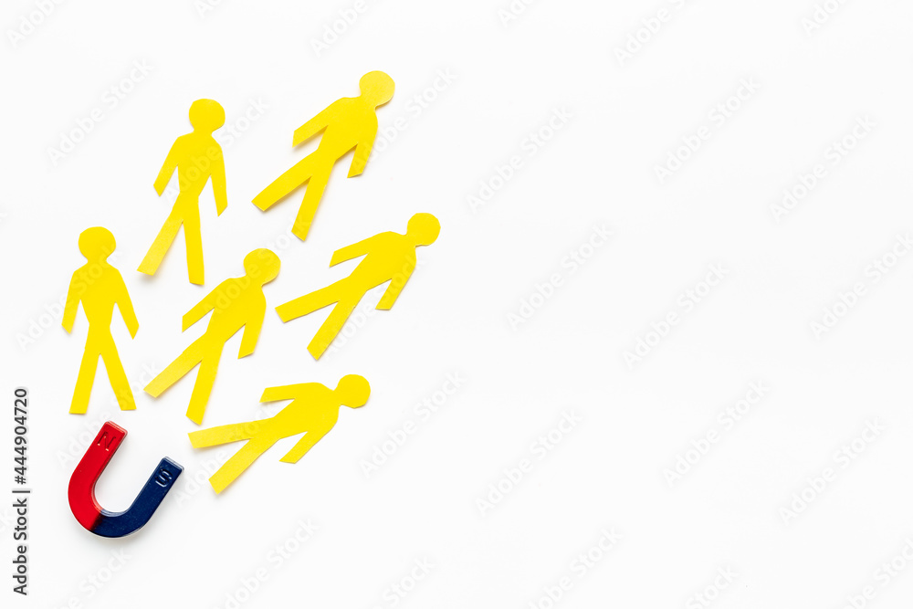 Horseshoe magnet pulls human figures. Increase team and recruiting concept Horseshoe magnet pulls human figures. Increase team and recruiting concept