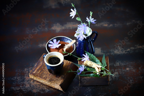 Chicory drink in a mug. Flowers and leaves of chicory. Still life with chicory.