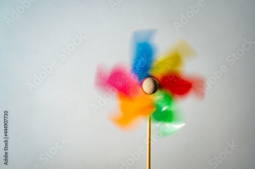 Colorful turning pinwheel homemade on white background. Summer fun © NadiaA
