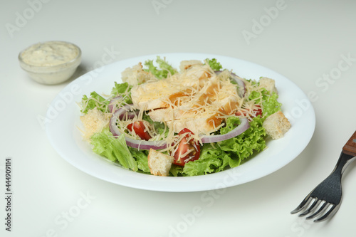 Concept of tasty eating with Caesar salad on white background