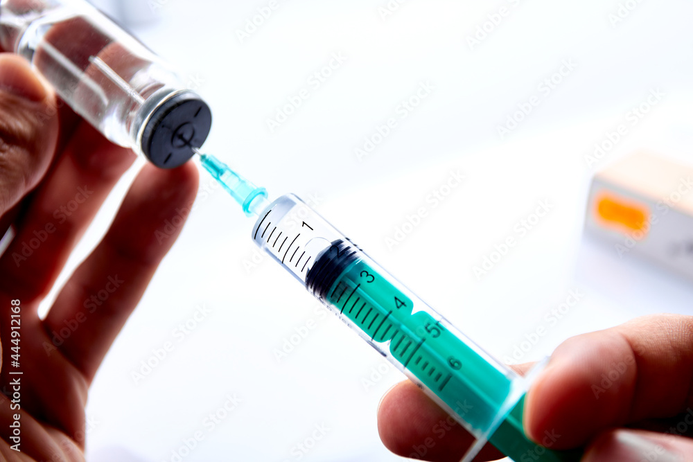 Vaccine in vial with syringe Vaccine in vial with syringe