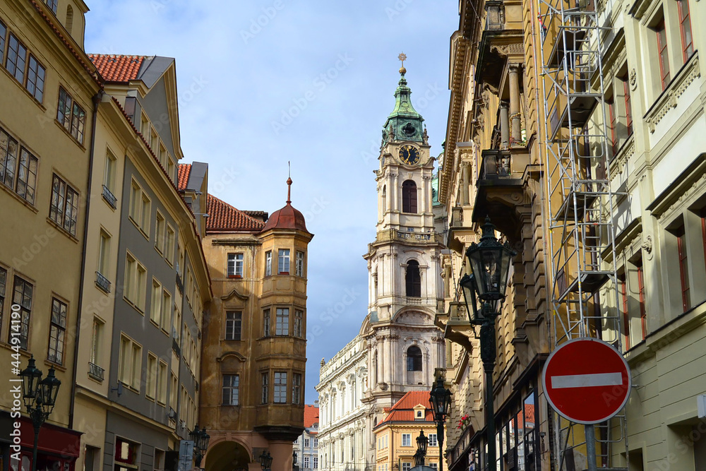 The street of the Old Town of Prague and The Church of Saint Nicholas (Czech: Kostel svatého Mikuláše) in the background. Prague, Czech Republic.