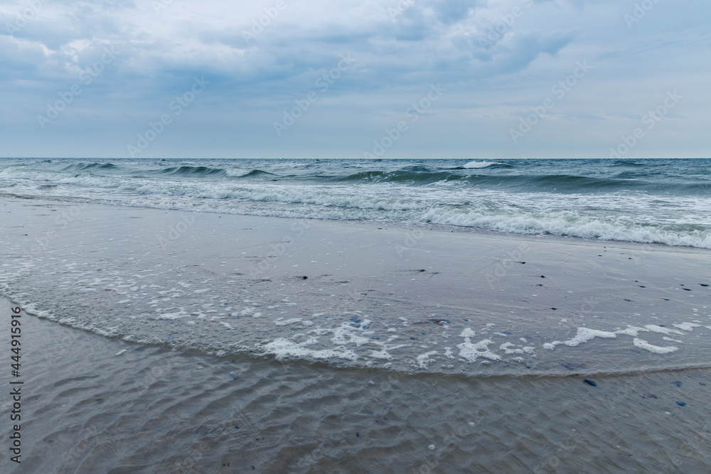 Baltic Sea coast in Poland, waves, sea foam, sky and beach Baltic Sea coast in Poland, waves, sea foam, sky and beach