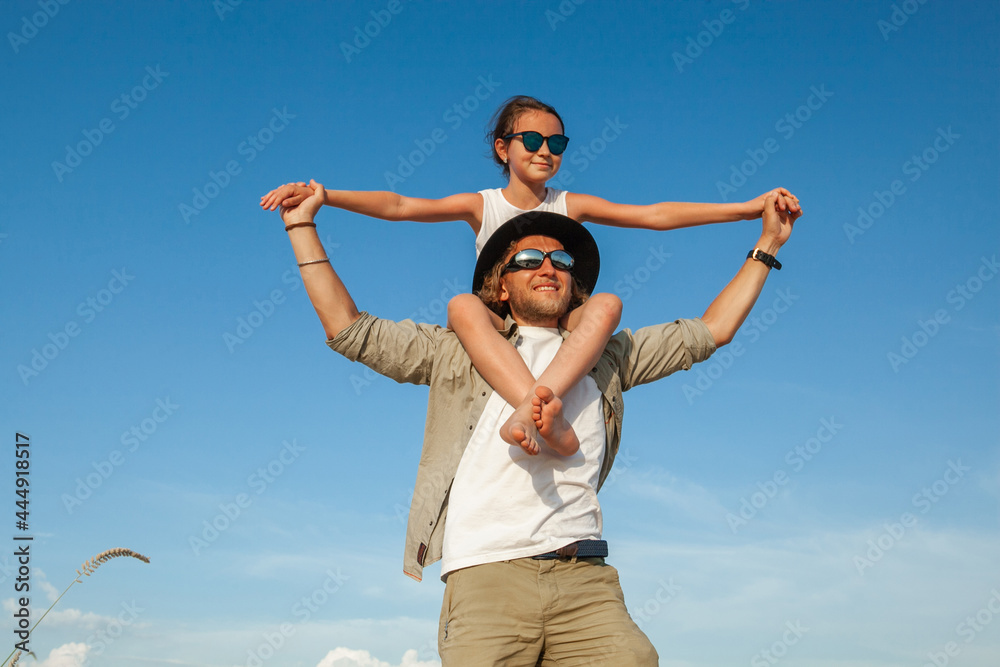 a man holds a child on his shoulders while in the desert in the summer a man holds a child on his shoulders while in the desert in the summer