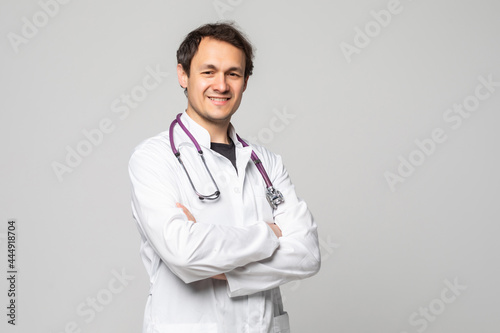 Smiling medical doctor with stethoscope over white background