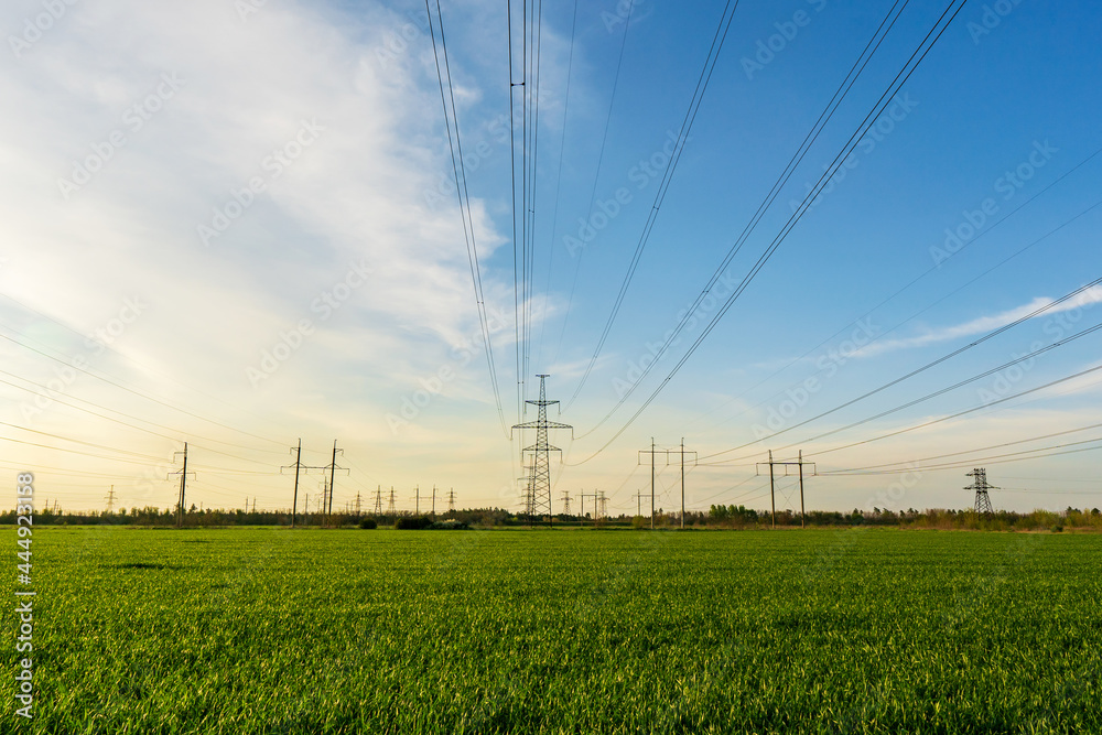 power lines run through green farmland with rich blue skies power lines run through green farmland with rich blue skies