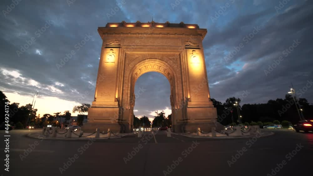 Moving shot of going through the Arch of Triumph Bucharest Square during corona virus pandemic, at dusk