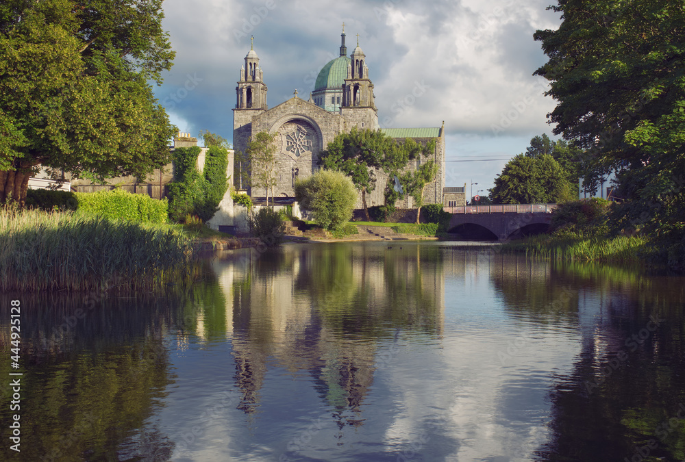 Beautiful scenery of Galway cathedral by the canal of Corrib river with reflecions in the water in Ireland 