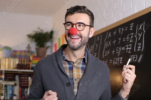 Quadro su tela Humorous teacher wearing clown nose in classroom