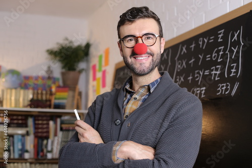 Humorous teacher wearing clown nose in classroom photo