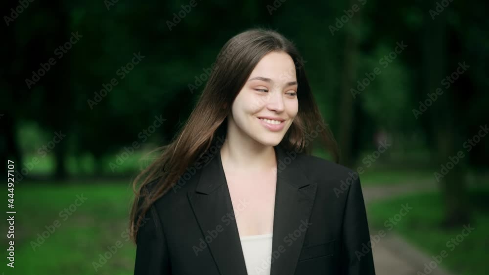 Portrait of an attractive brunette woman walking in the park on a sunny day and smiling. The face of a happy beautiful woman in summer outdoor Portrait of an attractive brunette woman walking in the park on a sunny day and smiling. The face of a happy beautiful woman in summer outdoor