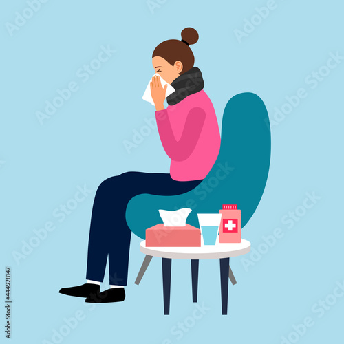 Sick woman with flu disease sitting on armchair. Female suffering from cold and sneezing in napkin. Flu season.