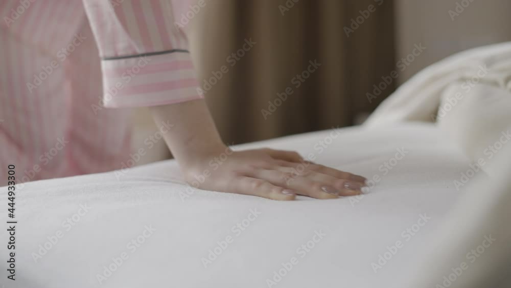 Young woman touching the mattress, trying the softness and quality, good sleep Young woman touching the mattress, trying the softness and quality, good sleep