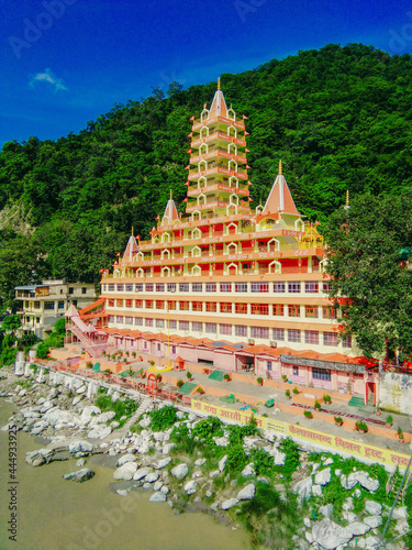 Scenic view of Trayambakeshwar Temple in Rishikesh with green mountains and blue sky photo