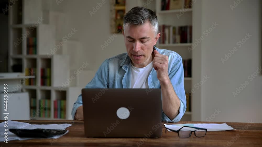Successful intelligent adult gray haired caucasian broker, freelancer, mentor or manager, working remotely, chatting on video call with client or employee, gesturing hands, smiling. Online meeting Successful intelligent adult gray haired caucasian broker, freelancer, mentor or manager, working remotely, chatting on video call with client or employee, gesturing hands, smiling. Online meeting