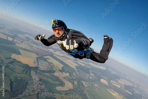 Male skydiver with the camera freefalling in the sky