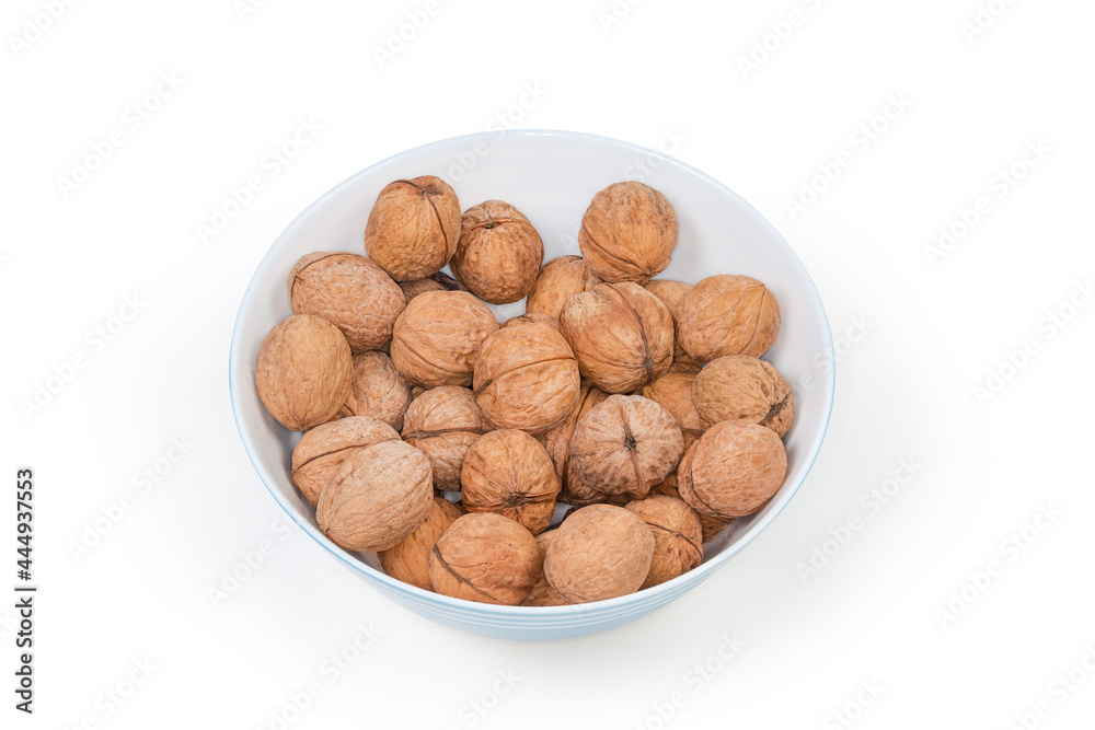 Whole walnuts in their shells in bowl close-up Whole walnuts in their shells in bowl close-up