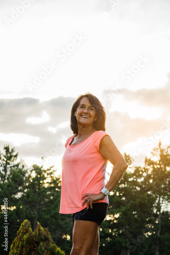 Portrait of hispanic woman with sportswear looking at camera and laughing © Alberto