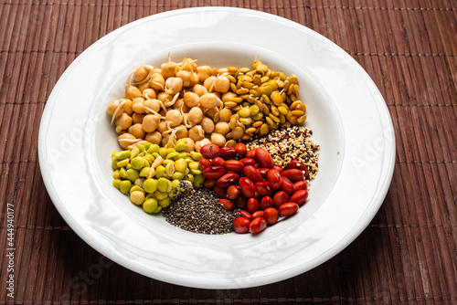 Vegan food. Sprouted grains in white dish on bamboo background