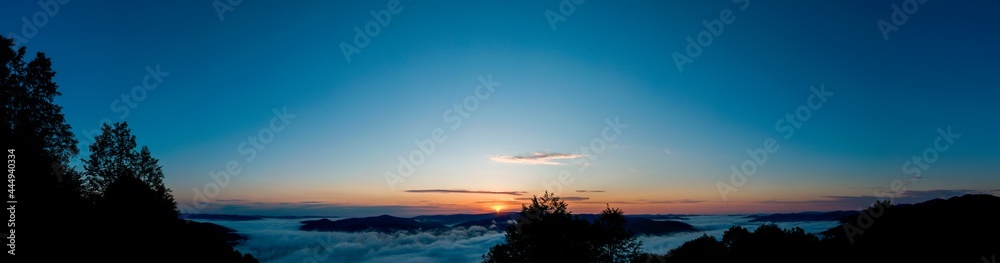 Fototapeta premium bright sunrise in the mountains with blue sky