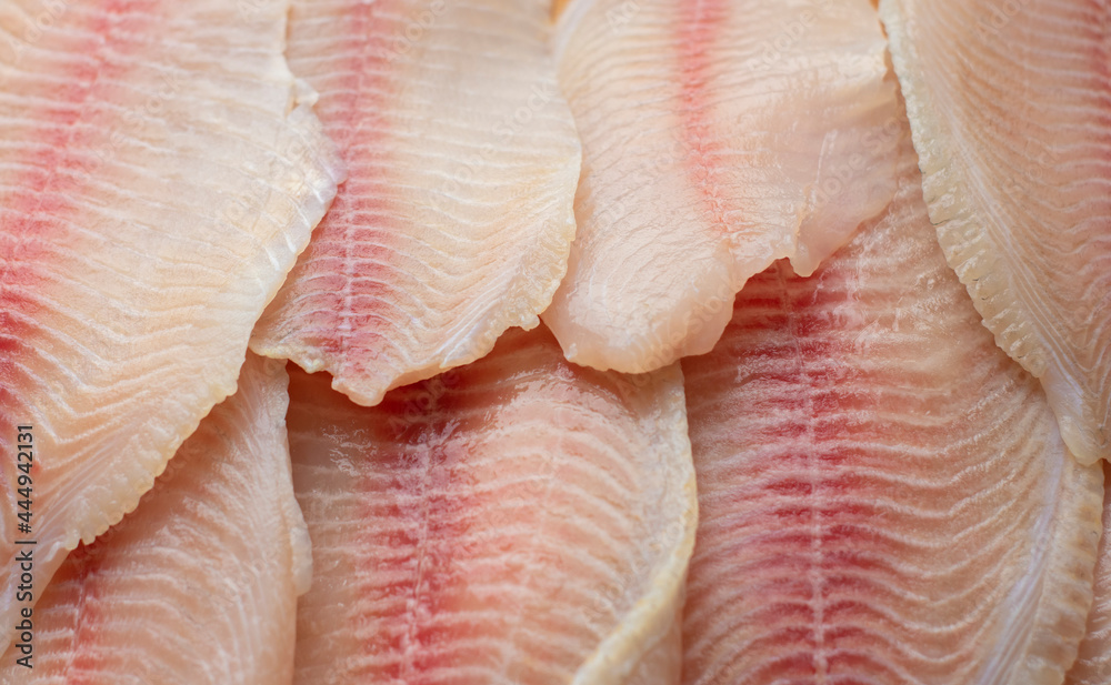 pieces of raw fish, tilapia lie on the surface. Fresh fish, seafood, vitamins, d3. The benefits or harms of seafood, deficiency pieces of raw fish, tilapia lie on the surface. Fresh fish, seafood, vitamins, d3. The benefits or harms of seafood, deficiency