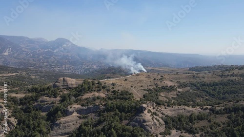 Controlled and prescribed forest fire. Flames and smoke clouds. Aerial drone wide shot.