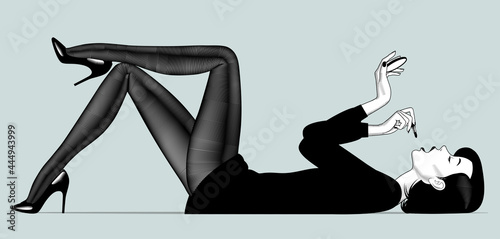 Lying undressed woman paints lips in dark pantyhose and shoes
