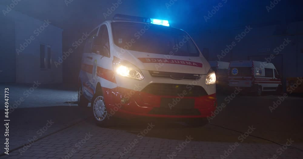 Ambulance car with blue and red lights at street in dark evning. Paramedical vehicle at city outdoors at night shift. Automobile of medics in dark. Ambulance car with blue and red lights at street in dark evning. Paramedical vehicle at city outdoors at night shift. Automobile of medics in dark.